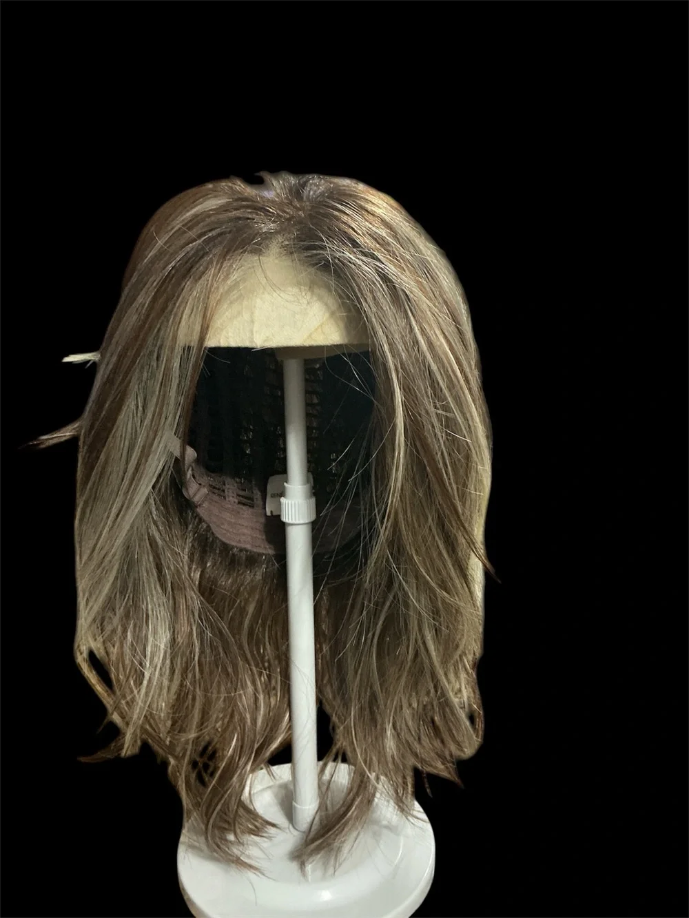 Rene of Paris Natural Layered Women's Wig in Light Brown with Blonde Highlights.